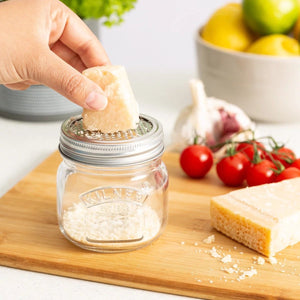 Person Grating Cheese into Jar