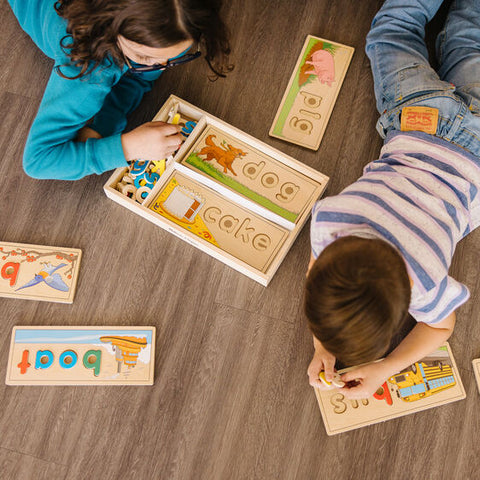 See and spell learning toy. Children playing.