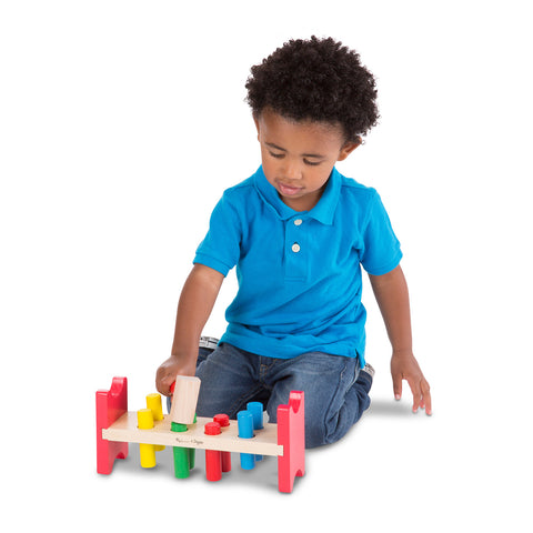 child using pounding toy and hammer
