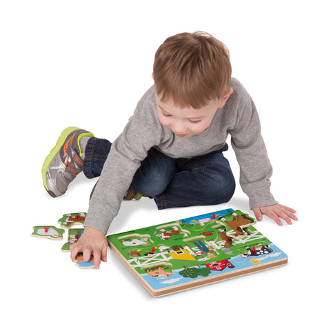 boy using Old MacDonald sound puzzle