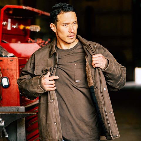 Man wearing a Ariat men's Rebar DuraCanvas Sherpa-Lined Coat