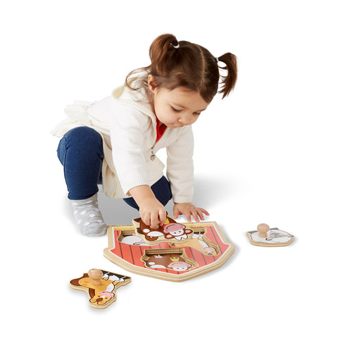 girl using barnyard knob puzzle