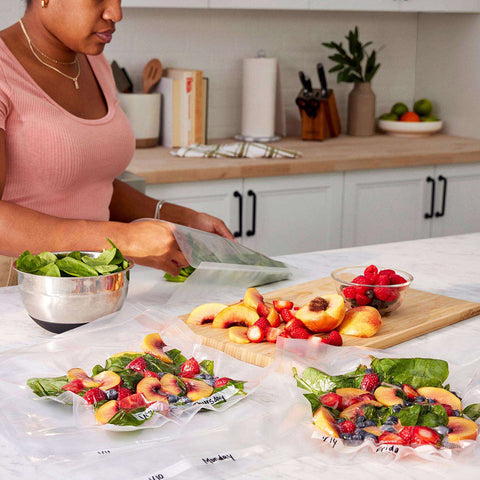 Woman Vacuum Sealing Produce