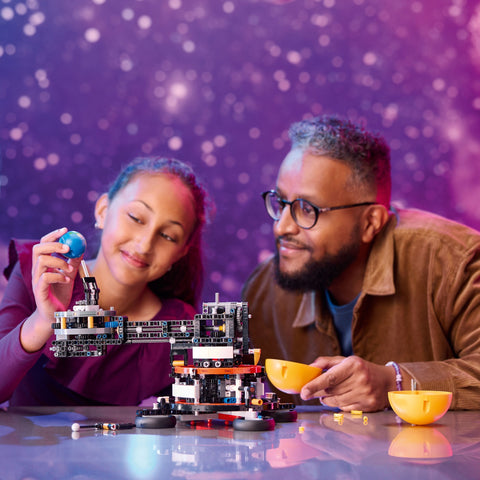 Girl & dad assembling LEGO Planet Earth & Moon in Orbit model kit
