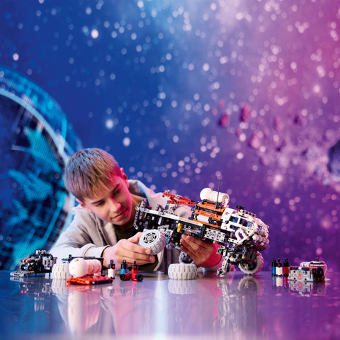 Boy assembling a LEGO Mars Crew Exploration Rover