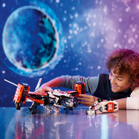 Boy playing with LEGO VTOL Heavy Cargo Spaceship LT81 on tabletop