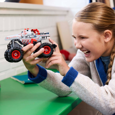 Girl examining the LEGO Technic Monster Jam ThunderROARus Pull-Back Truck 42200