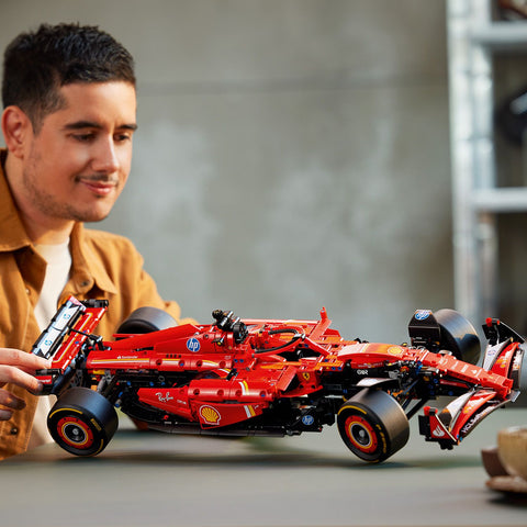 Men looking at LEGO Technic Ferrari SF-24 F1 Car Model Kit for Adults 42207