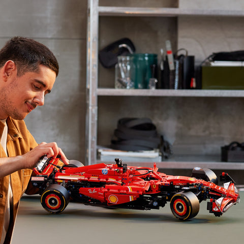 Man assembling the LEGO Technic Ferrari SF-24 F1 Car Model Kit for Adults 42207
