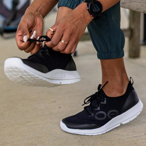 Woman Lacing Up Shoes