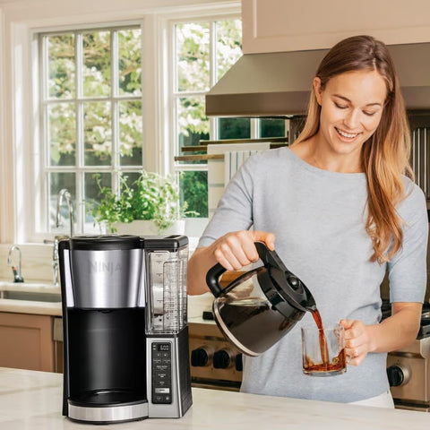 Ninja Black Coffee Maker CE251 showing lady pouring a mug of coffee