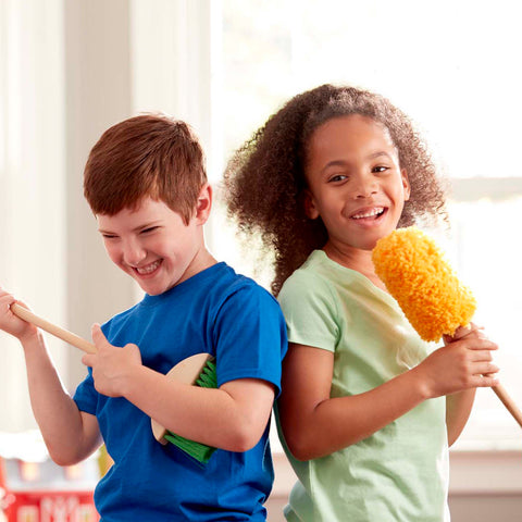 children with toy brorom and duster