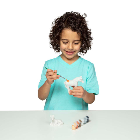 girl painting mare figurine