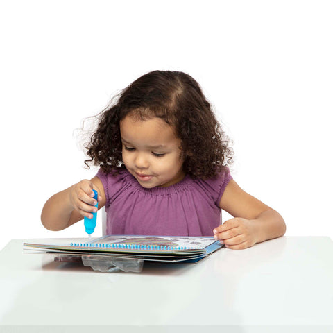girl using water paint pen on water wow town pad