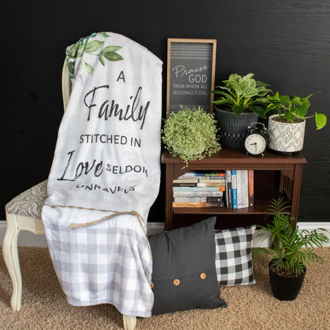 A Family Stitiched in Love Seldom Unravels Fleece Throw in Living Room