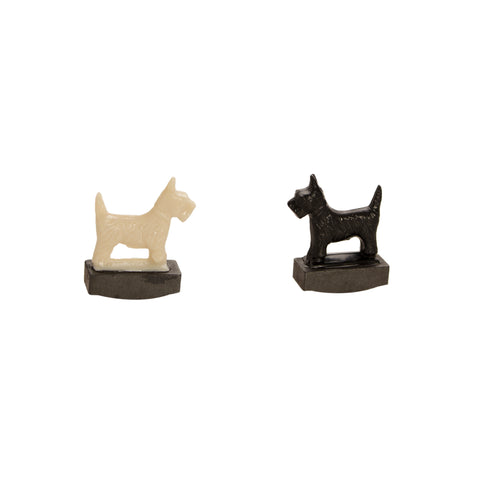 A set of tricky dogs, one black, one white.