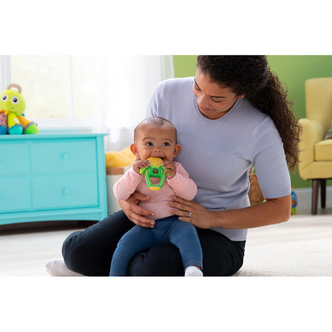 Mom holding baby with teether
