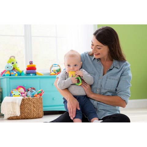 Mother holding baby with teether