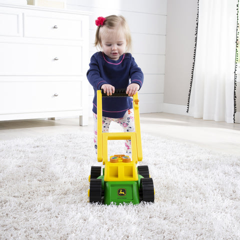 Little girl with lawn mower