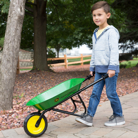Boy pushing wheel barrow