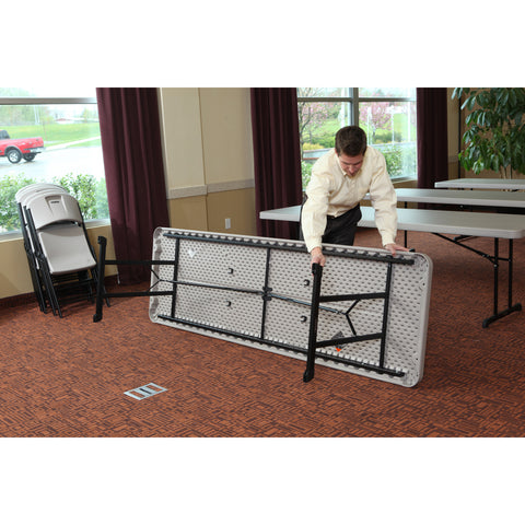 Man folding Lifetime table