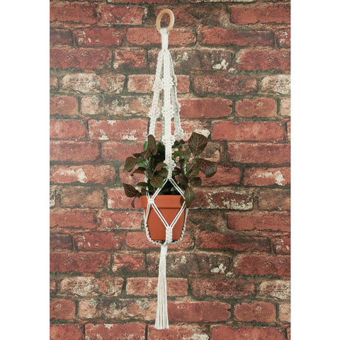 Macrame hanger in front of brick