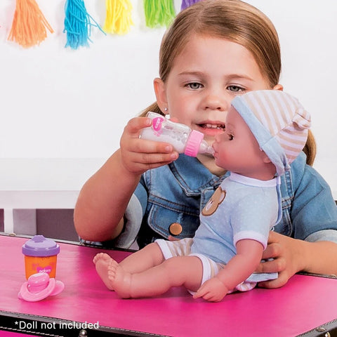 Girl giving doll a bottle