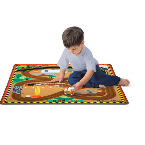 Child playing on Melissa & Doug construction zone rug.