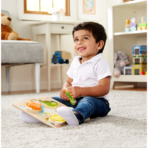 Boy playing with peek-a-boo puzzle