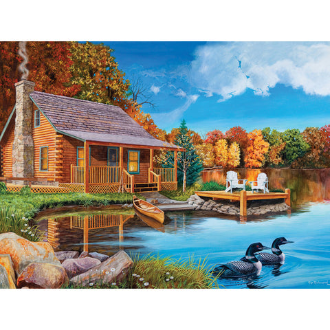 Two loons swim away from shore as smoke curls from the chimney of a rustic log cabin. A canoe on the shore begs for a cruise among the fiery grandeur of autumn reflected on the glassy lake. Two adirondack chairs sit on a wooden dock