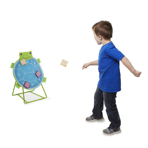 child throwing Bean Bag at target