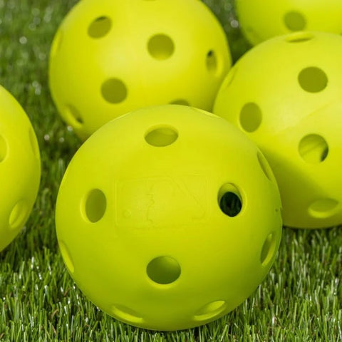 yellow softballs in the grass