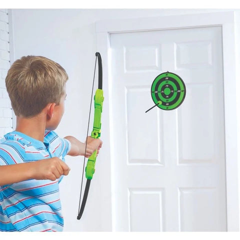 boy shooting arrow at target on door