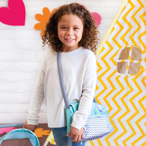 Girl using doll diaper bag