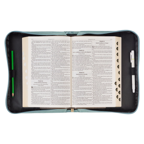 Bible cover open with Bible and pens inside