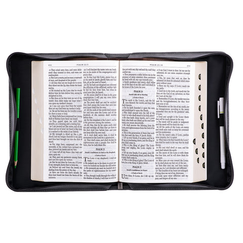 Bible cover open with Bible and pens inside