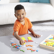 child playing with tiles