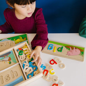 See and spell learning toy. Child playing.