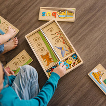See and spell learning toy. Children playing.