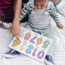 Mother helping child put puzzle together