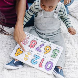 Mother helping child put puzzle together