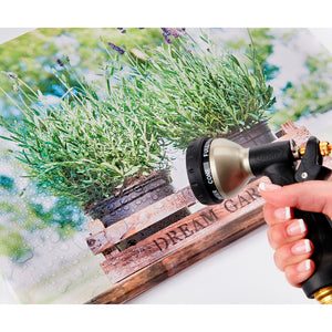 Woman Spraying Canvas with Hose