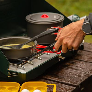 man cooking with cookware