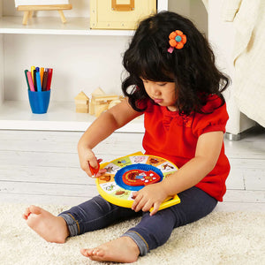 Little Girl Playing with See N' Say Toy