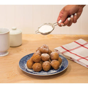 Kitchen Mesh Strainer 30010
with powdered sugar being sprinkled over donuts