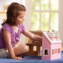 child playing with dollhouse