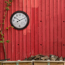 Indoor and Outdoor Wall Clock 404-3015 displayed on outdoor wall 