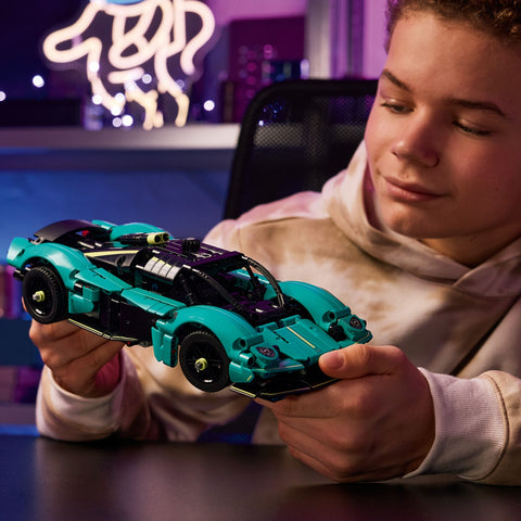 Boy holding a LEGO Technic Aston Martin Valkyrie Car 42208