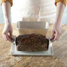 Person Lifting Meatloaf Out of Pan