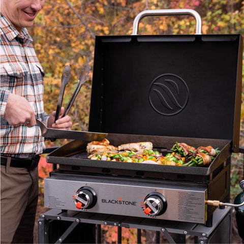 Man using Blackstone 22-inch 2-Burner Tabletop Outdoor Griddle